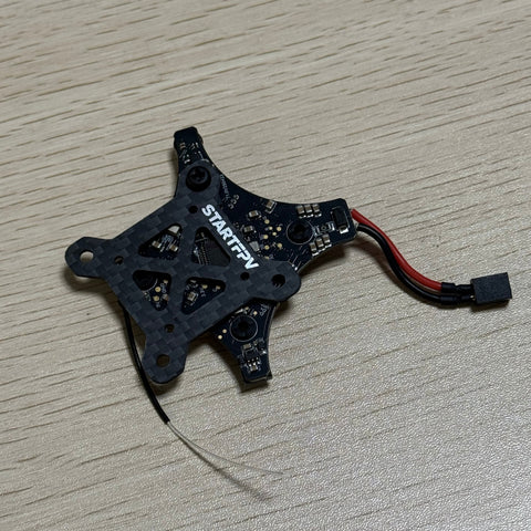 Front view of STARTFPV integrated FPV flight controller, featuring carbon fiber mounting board, high-performance flight control chip, and integrated receiver, FCC/CE/ROHS certified, suitable for FPV drone customization and bulk orders from global distributors.